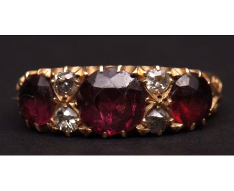 Early 20th century 18ct gold amethyst and diamond ring, the centre circular facetted amethyst flanked by four small old cut c