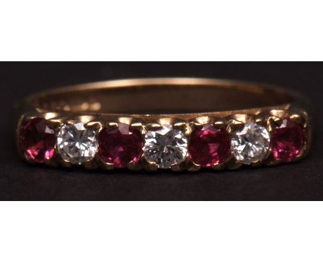 9ct gold ruby and diamond ring, alternate set with four small rubies and three small brilliant cut diamonds, (0.30ct approx),