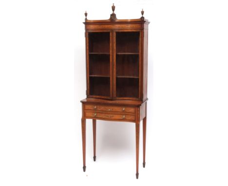 A good quality Edwardian satinwood side cabinet of slim proportion, the serpentine fronted top with three finials to the pedi