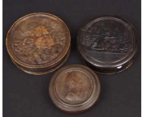 Group of three Georgian pressed horn snuff boxes, circular shaped   the first embossed with two figures in garden setting and
