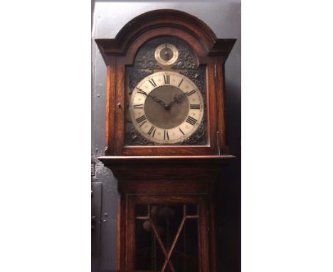 Mid-20th century oak cased triple weight driven longcase clock, the arched hood with overhanging cornice to a moulded throat 