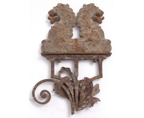 A late 18th/early 19th century cast iron gate finial formed as a pair of rampant lions, attached to remains of wrought iron g