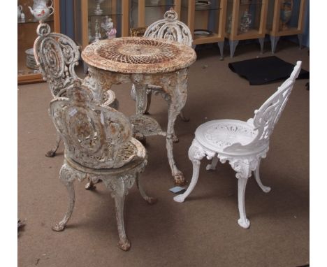 Vintage white painted cast iron garden set of circular table and four matching chairs in rococo style (one chair recently re-