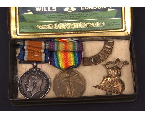 WWI pair comprising British War Medal and Victory Medal to 22628 Pte C Peggs, Norf R, together with a Norfolk Regt cap badge 