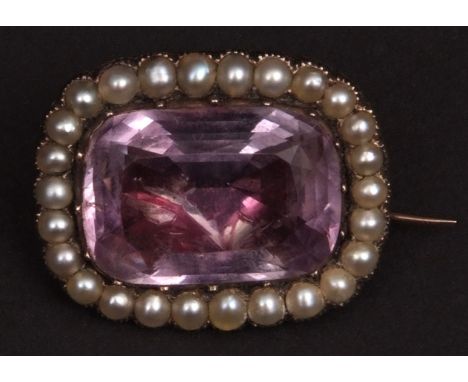 19th century gold framed brooch of shaped rectangular form, the centre with foil backed pale amethyst surrounded by seed pear