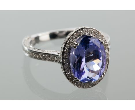 IMPRESSIVE TANZANITE AND DIAMOND CLUSTER RING
the central oval cut tanzanite 3.8 carats, surrounded by approximately 1.25 car