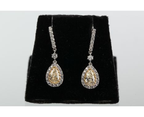 PAIR OF YELLOW AND WHITE DIAMOND DROP EARRINGS
the central pear cut diamonds each approximately 0.50 carats, surrounded by wh