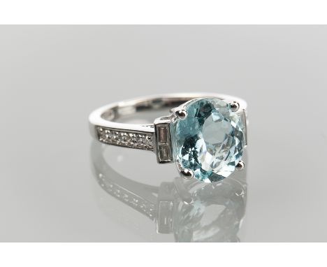 FINE AQUAMARINE AND DIAMOND RING 
set with a single oval aquamarine of approximately 2.71 carats flanked by two pairs of bagu