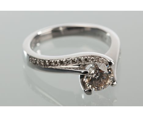 DIAMOND SOLITAIRE RING
the central diamond approximately 0.88 carats, on diamond shoulders, marked 750 for eighteen carat gol