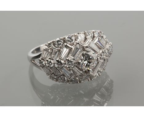 IMPRESSIVE PLATINUM TRAPEZE CUT DIAMOND CLUSTER DRESS RING 
set with brilliant and trapeze cut diamonds totalling approximate