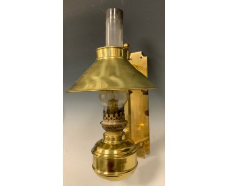 A late 19th century Adjustible Brass wall mounted oil lamp, converted for use with electricity. Provenance: collection label 