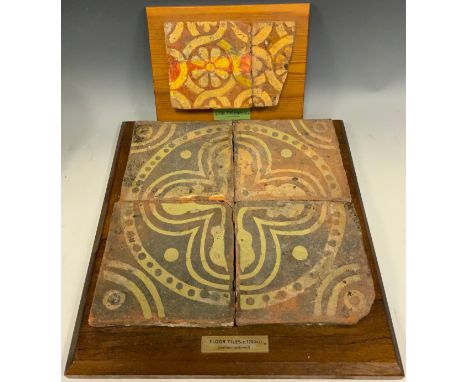 A set of four late medieval period terracotta floor tiles, with restoration to pattern, c. 1200; a reconstructed medieval til