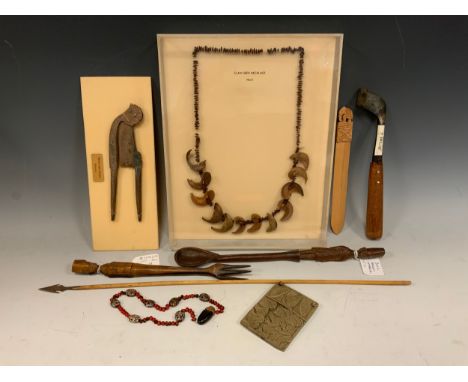 Ethnographic interest; an early 20th century Haitian claw-seed necklace, mounted in a museum-type display case; another seed 