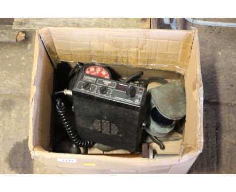 A box containing a CB radio; ships compass; small lamp etc