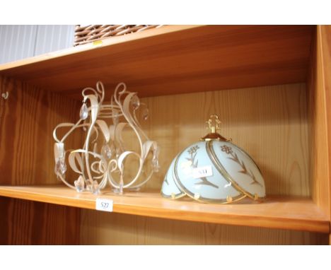 A metal light fitting together with a lamp shade