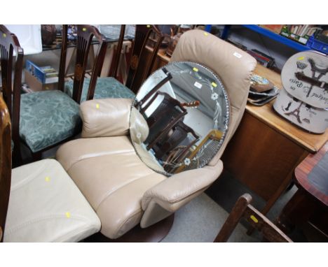 A leatherette upholstered swivel chair and similar foot stool