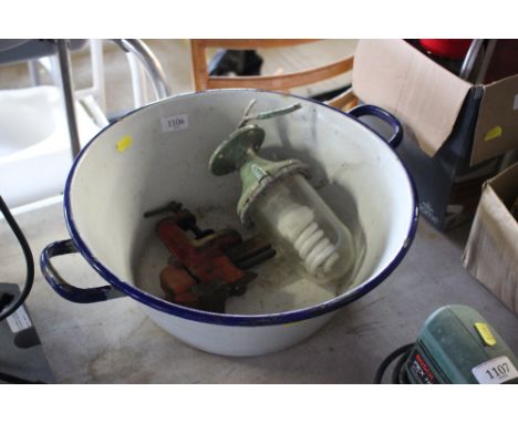 An enamel pail and contents of a light fitting and a bench vice