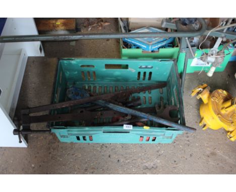A box of various tools to include a pipe vice; sash clamps etc