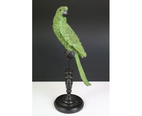 Model of a green parrot on a perch mounted on a turned wooden base, 43cm high 