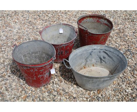 Three vintage red painted metal fire buckets (two inscribed 'FIRE' to sides), together with an oval twin handled galvanised p