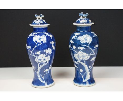 Pair of Chinese porcelain blue and white baluster vases and covers, decorated with prunus blossom, blue double ring mark to b