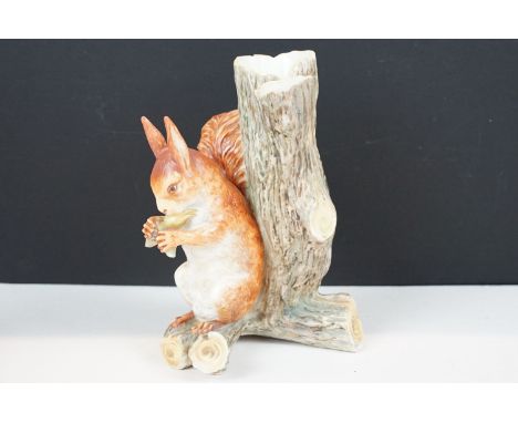 Royal Worcester porcelain figure of a red squirrel modelled seated by a tree stump eating a nut, impressed mark and registrat