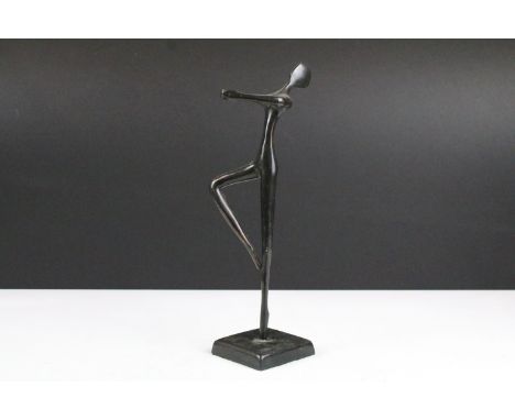 Bronze figure of a stylised ballerina performing a pirouette, raised on a square base, approx 28cm high 
