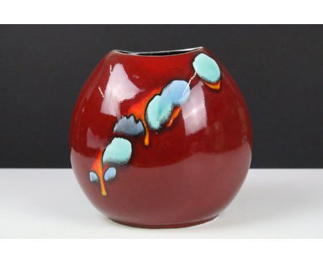 Poole pottery living glaze pattern vase having a red ground with blue detailing. Measures 18cm tall. 