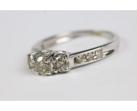 White gold diamond trilogy set ring with graduated shoulders 