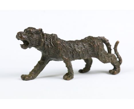 A Chinese bronze ornament in the form of a tiger. 