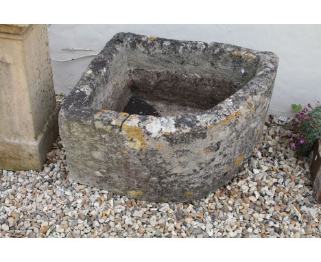 Stone corner planter having a right angle shape with curved front. Measures 69 x 59 x 37cm. 
