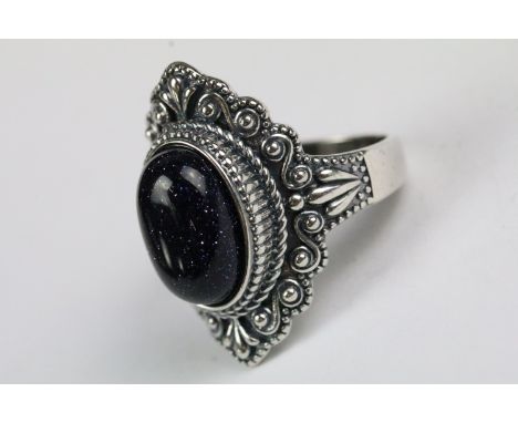 A ladies silver and purple stone ring, marked 925 to the shank. 