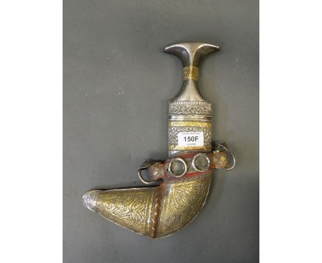 An Islamic ceremonial dagger with silver and gilt repoussé decoration and gilt thread sheath, with a horn handle, 12'' long 