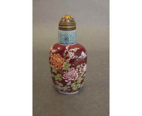 A Peking glass red ground enamel snuff bottle with foliate decoration, 4 character mark to base, 2½" high 
