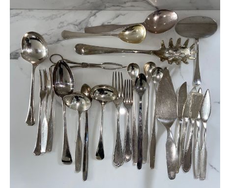 An assortment of silver plated flatware, including various servers, spoons etc. and a decorative ceramic tea cup and saucer (