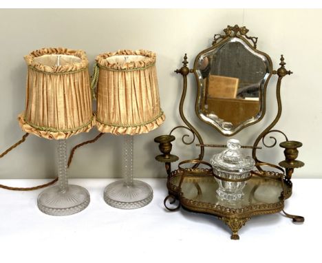 A 19th century gilt metal dressing table mirror; together with a moulded glass table candlestick lamps, the dressing mirror w