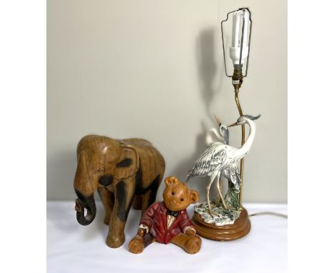 A modern table lamp base, with figures of Heron; together with a carved wood elephant and a teddy bear (3)