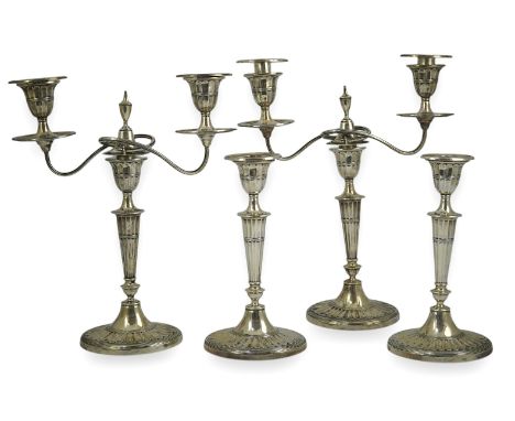 A pair of Edwardian silver two branch, two light candelabra, by Walker &amp; Hall and a pair of matching candlesticks, of ova