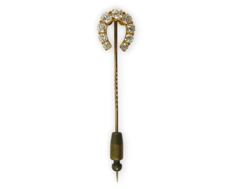 An early 20th century gold and nine stone graduated old cut diamond set horseshoe stick pin, 68mm, gross weight 4.6 grams.  O