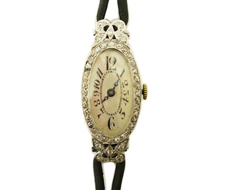 A lady's 1920's/1930's platinum and diamond cluster set cocktail watch, with oval Arabic dial, case diameter 17mm, on a twin 