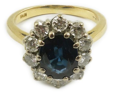 A modern 18ct gold, sapphire and diamond set oval cluster ring, size K/L, gross weight 4.8 grams.  Overall condition is good.