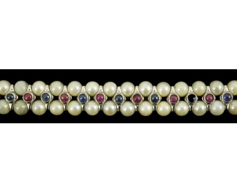 A late 20th century 18k white gold and two row cultured pearl bracelet, set with single row of cabochon rubies and sapphires,