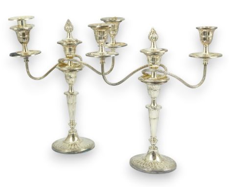A modern pair of silver two branch three light oval candelabra, by James Dixon and Sons Ltd, with reeded arms on oval fluted 