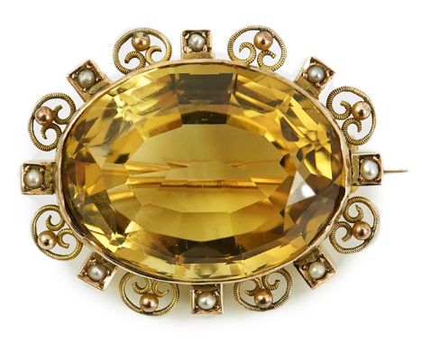 A late Victorian 9ct gold, citrine and seed pearl cluster set oval brooch, with scroll and sphere border, 34mm, gross weight 