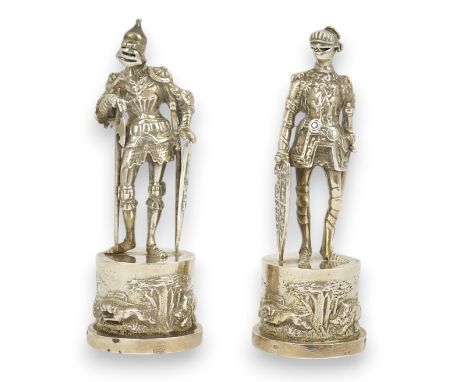Two similar late 19th/early 20th century Hanau? silver miniature model Knights, makers mark HT, with hinged visors, on fixed 