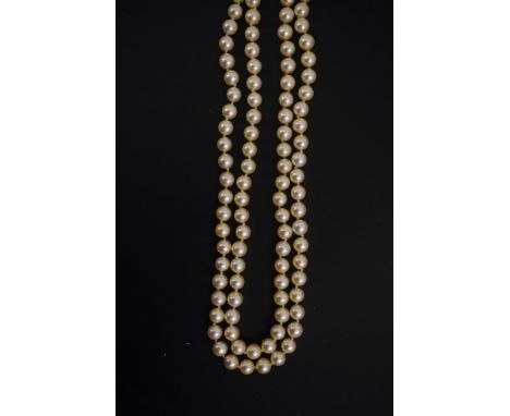 A modern double strand cultured pearl necklace, with 18k gold and diamond set twin ring clasp, and two diamond set spacers, 9