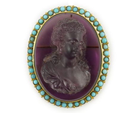 A late 19th/early 20th century gold and turquoise enamel? mounted oval amethyst paste set brooch, carved in relief of a lady 