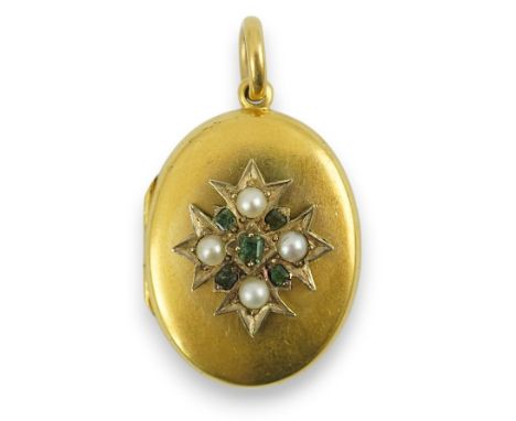 A Victorian gold, split pearl and emerald cluster set oval locket, overall 36mm, gross weight 7.6 grams.  Brown glue/residue?