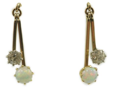 A pair of 9ct gold, white opal and diamond set double drop earrings, 23mm, gross weight 2.2 grams.  Overall condition is good