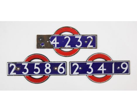 Set of London Underground enamel 'bull's eye' stock-number plates. Nos. 23586, 23419, ...4232 (badly damaged). (3). Provenanc